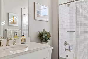 Full bathroom featuring shower / bath combo and vanity