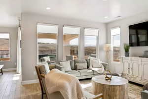 Living area featuring light wood-style floors and recessed lighting