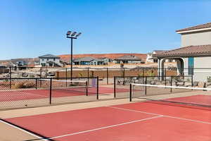 View of tennis court featuring a residential view and community basketball court