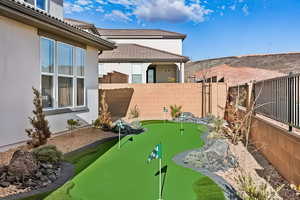 View of yard featuring a putting area
