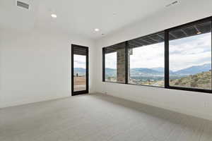 Spare room with light colored carpet, recessed lighting, and a mountain view