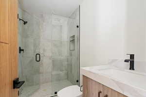 Bathroom featuring a stall shower and vanity