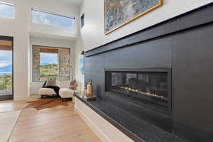 Detailed view of wood finished floors and a glass covered fireplace