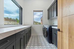 Laundry room featuring cabinet space and independent washer and dryer