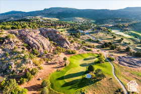 Aerial view of a mountainous background and a golf club