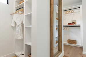 Spacious closet featuring wood finished floors