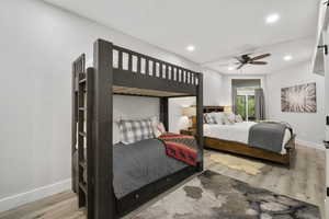 Bedroom featuring bunk beds with an additional bed with wood finished floors, a ceiling fan, and recessed lighting