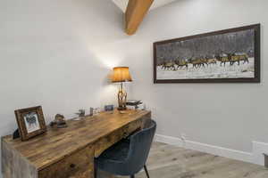 Office Area off of Living Room featuring wood finished floors and beam ceiling