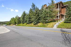 View of asphalt street featuring stairs to Condo Building