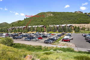 Uncovered parking lot at Snow Park Lodge featuring a mountain view with marked location of subject property