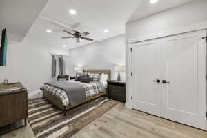 Primary Bedroom with light wood-style flooring, a ceiling fan, and recessed lighting