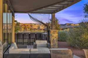 Patio terrace at dusk featuring an outdoor hangout area