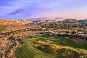 Aerial view at dusk of a mountain view, view of golf course, and a residential view
