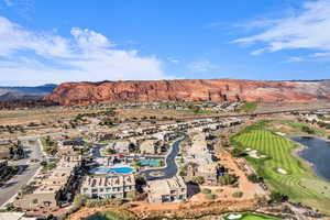 Aerial view of property and surrounding area featuring a water and mountain view and a golf club