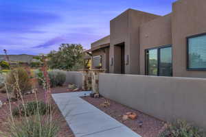 Property exterior at dusk featuring stucco siding