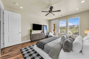 Bedroom with access to outside, wood finished floors, recessed lighting, and ceiling fan