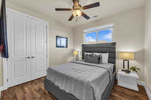 Bedroom with a closet, wood finished floors, and ceiling fan
