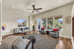 Living room with ceiling fan, recessed lighting, and wood finished floors