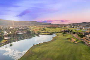 Aerial view at dusk of golf course view and a water and mountain view
