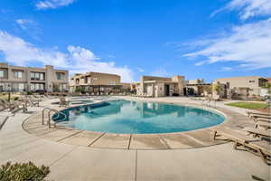 Community pool featuring a patio and a residential view