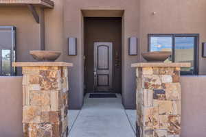 Property entrance featuring stone siding and stucco siding