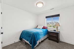 Carpeted bedroom featuring baseboards