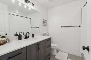 Bathroom with vanity and tile patterned flooring