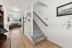 Staircase featuring wood finished floors and baseboards