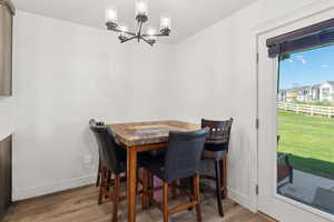Dining space featuring a chandelier and light wood-type flooring