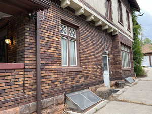 View of property exterior with brick siding