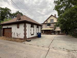 View of front of house with a chimney and stucco siding