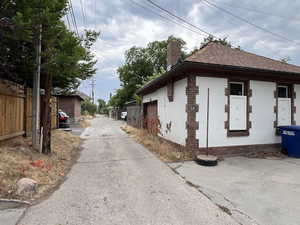 View of home's exterior with roof with shingles and a chimney