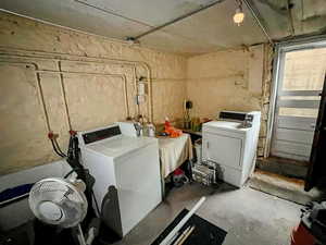 Unfinished below grade area with washing machine and dryer