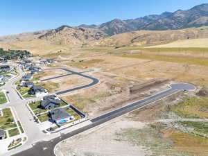 Aerial view of property's location with a mountain backdrop