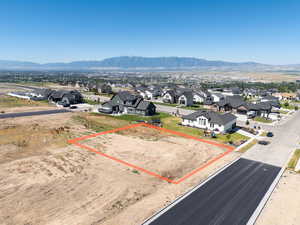 Aerial view of residential area with mountains and property parcel outlined