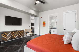 Bedroom featuring granite tiled floors, ensuite bath, recessed lighting, and ceiling fan