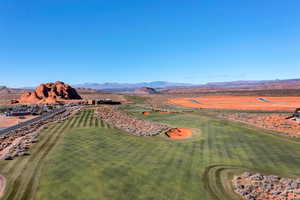 Aerial view of a mountain backdrop and a golf course