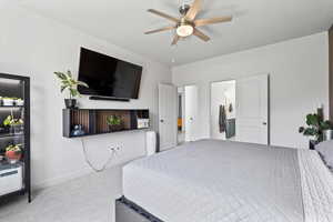Bedroom featuring carpet floors and baseboards