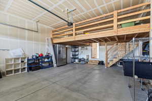 Garage featuring stainless steel fridge