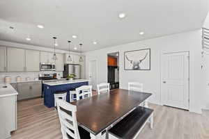 Dining area featuring light wood-type flooring and recessed lighting
