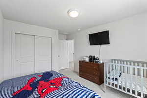 Bedroom featuring a closet and carpet floors