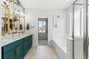 Full bathroom with double vanity, a garden tub, and tile patterned floors