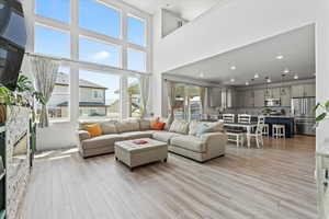 Living room with light wood-style floors and recessed lighting