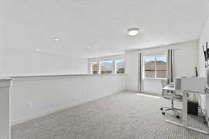 Unfurnished office with carpet, a textured ceiling, and recessed lighting