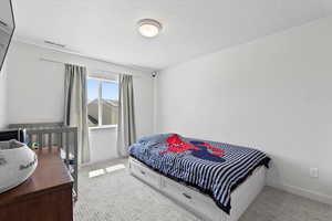 Carpeted bedroom with baseboards