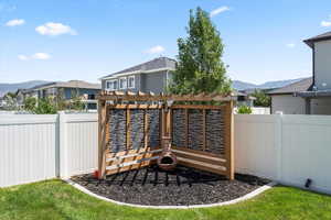 Fenced backyard with a mountain view and a pergola