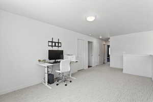 Carpeted office featuring baseboards