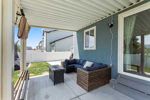 Fenced backyard featuring a patio area and an outdoor hangout area