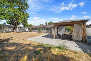 Fenced backyard with a gazebo, a patio, and an outdoor living space