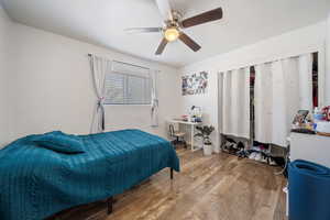 Bedroom featuring wood-type flooring and ceiling fan